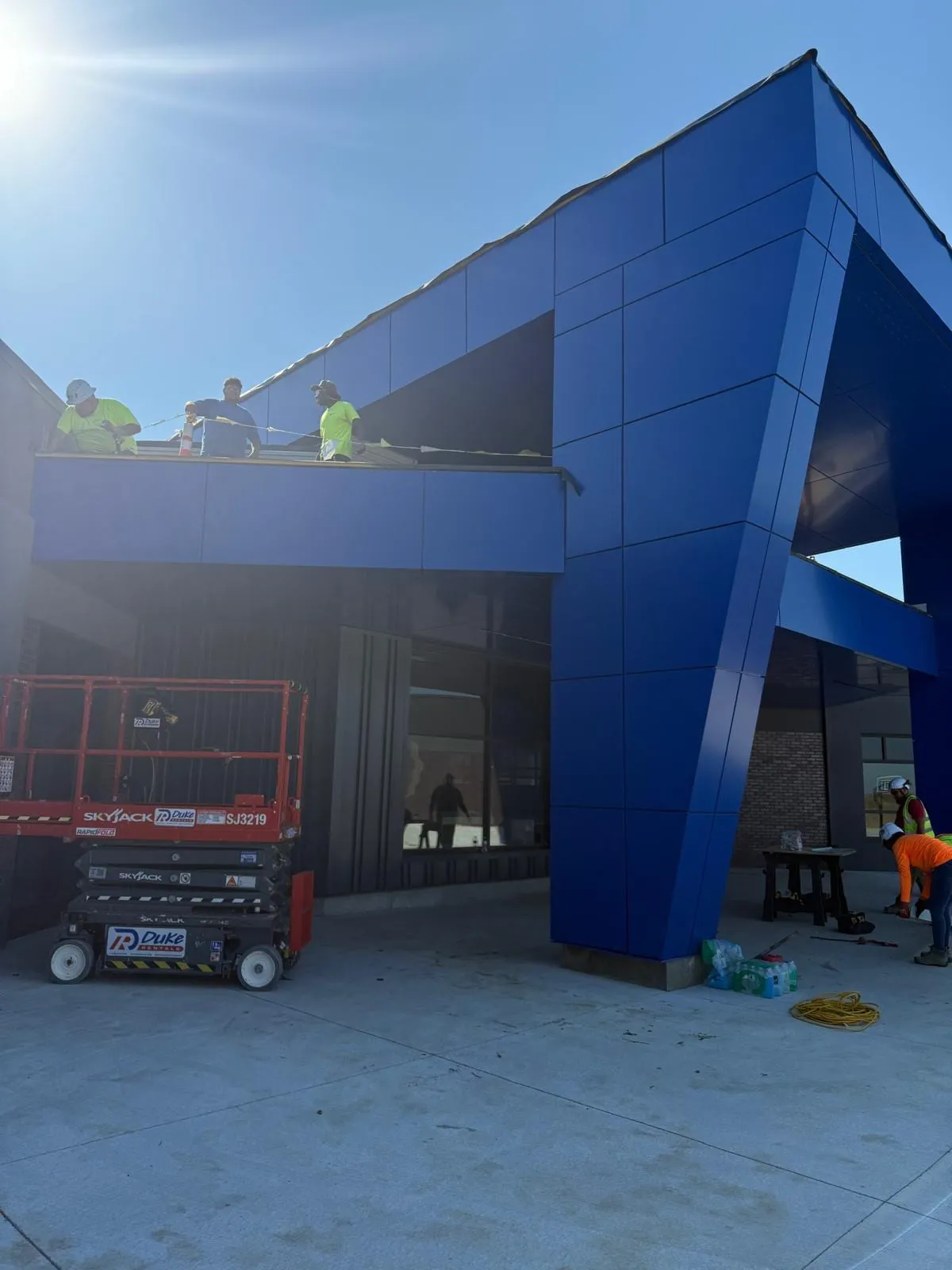 An LG Solutions crew setting the cobalt ACM entry canopy at Stone Pointe Elementary in Elkhorn, Nebraska.